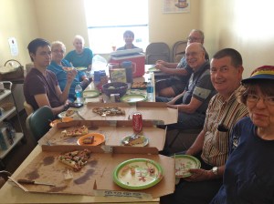 A happy group makes quick work of three pizzas. 